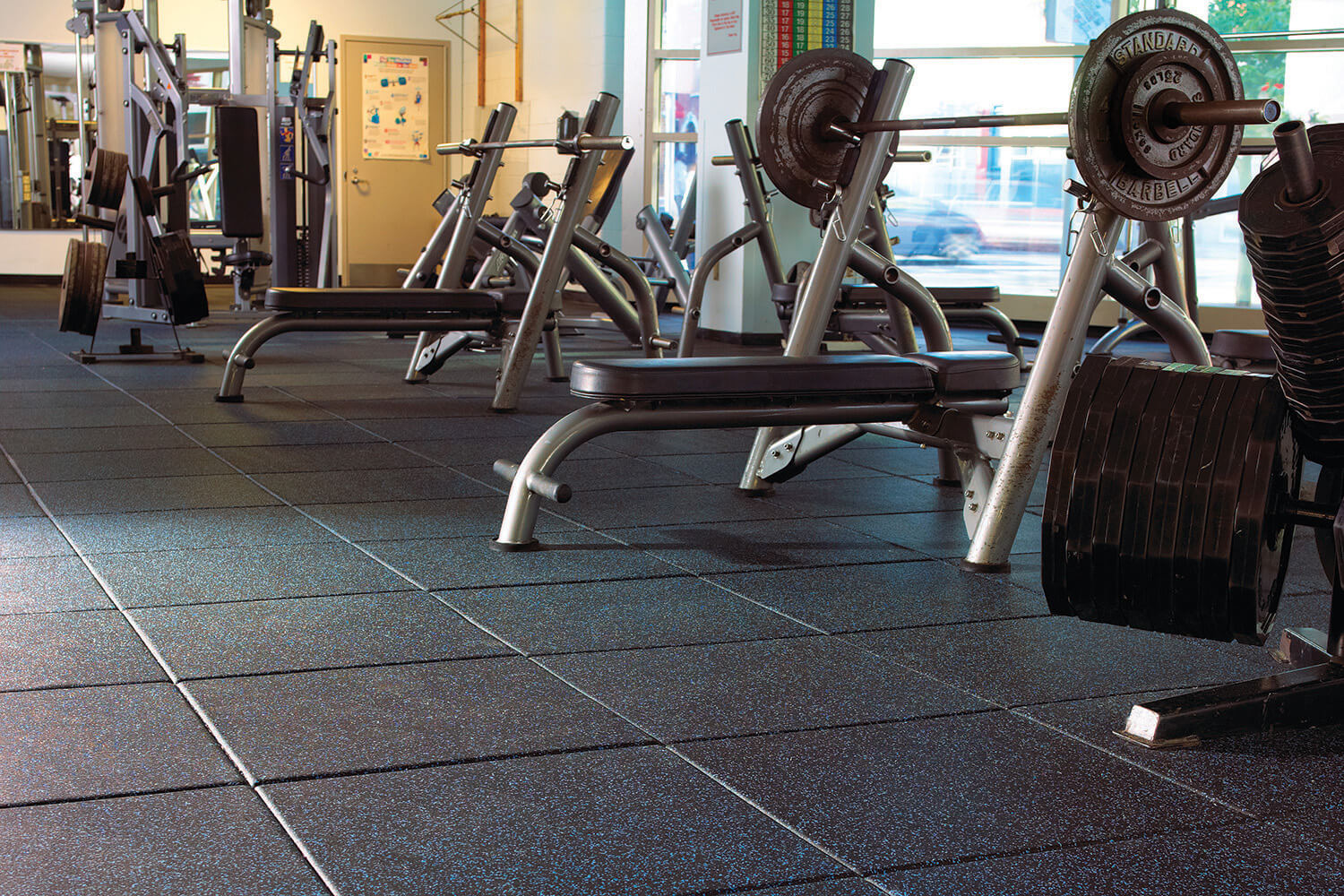 Rubber gym flooring tiles installed